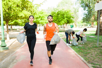 Young woman and man practicing plogging