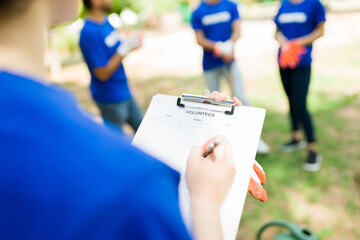 Volunteer taking notes after planting new trees