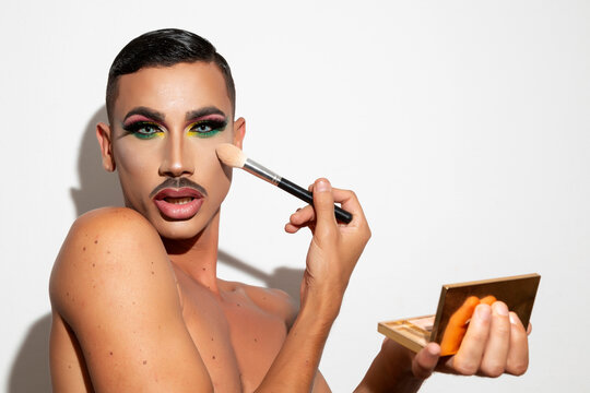 man with drag queen makeup on white background