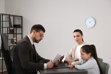 Mother and daughter having meeting with principal at school
