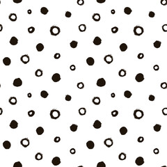 Seamless pattern with black circles scattered on white background. Hand drawn polka dot vector ornament. Modern abstract design for print or textile. Different grunge effect rounded spots and circles