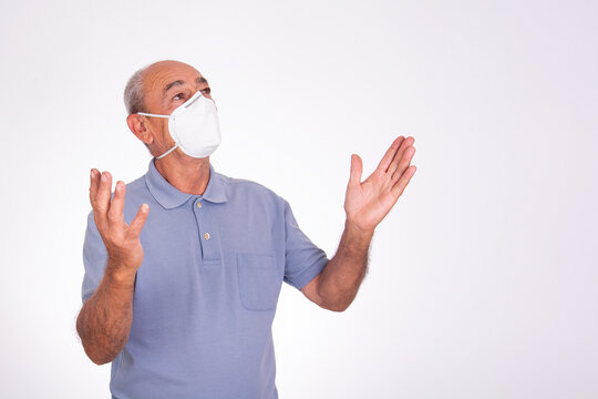 Elderly Man With Arms Up Wearing Covid Protective Mask, On White Background.