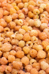 Ripe yellow raspberries, background. Many plucked yellow berries, Summer concept