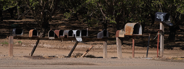 Fototapeta na wymiar Row of Unknown Open Mailboxes Just Waiting For Mail