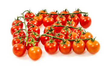Bunches of round red ripe cherry tomatoes with green branches on white surface