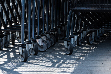 Fototapeta na wymiar Wheels of shopping trolleys stacked after eachothers.