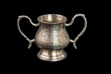 Close up view of vintage silver silverware isolated on black background. 