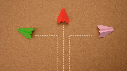 three paper airplanes fly in different directions on a brown background. Concepts of decisions,...