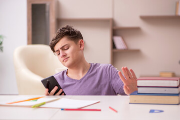 Schoolboy preparing for exams at home
