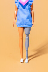female doll with a prosthetic leg. Focus on low part of body