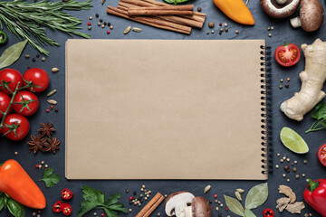 Open recipe book and different ingredients on black table, flat lay. Space for text - obrazy, fototapety, plakaty
