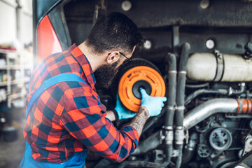 Obraz na płótnie Canvas Professional bus mechanic working in vehicle repair service.