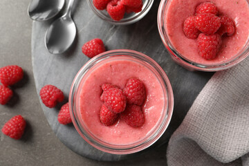 Delicious raspberry mousse served on grey table, flat lay