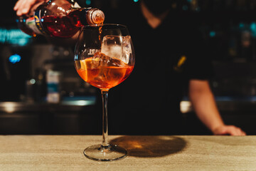 Expert barman is making cocktail at night club