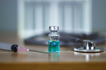 One bottle of vaccine on the table subcutaneous vaccination Vaccination and syringes with a stethoscope health medical concepts, treatment concepts