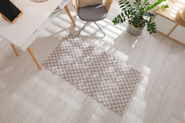 Stylish rug with pattern on floor in room, above view