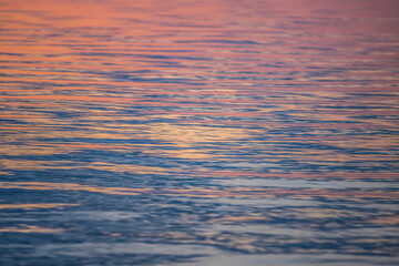 The texture of the water surface in the sunset rays