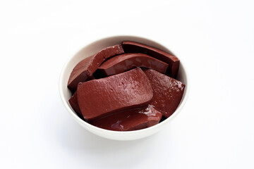 Pork blood pudding in white bowl on white background.