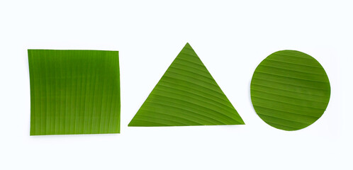 Cut banana leaves into square, triangle and circle shape on white background.