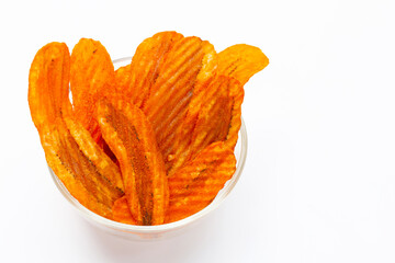 Spicy snack, Banana slice chips paprika flavor in glass bowl on white background.