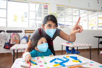 back to school, teacher and student taking classes wearing face mask, after coronavirus pandemic,...