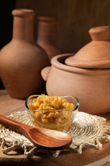 Ambrosia dulce de leche in a setting decorated with accessories that reference Minas Gerais and the Brazilian Northeast