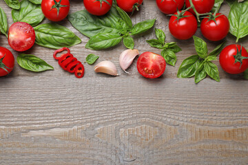 Fototapeta na wymiar Flat lay composition with fresh basil leaves and vegetables on wooden table. Space for text