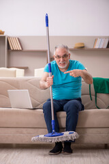 Old man cleaning the house