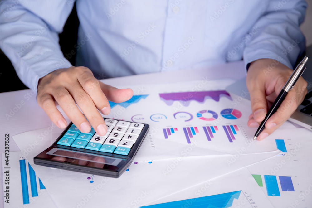Aufkleber hands of businessman calculate tax with calculator while laptop computer on desk, man planning finan