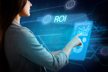 Business, Technology, Internet and network concept. Young businessman working on a virtual screen of the future and sees the inscription: ROI