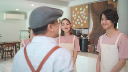 4K Asian male coffee shop manager briefing man and woman staff team before working. Small business cafe and restaurant owner instruct part time employee preparing service to customers before opening