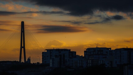 Fototapeta na wymiar Beautiful colorful dramatic sunset sky over silhouette of the city