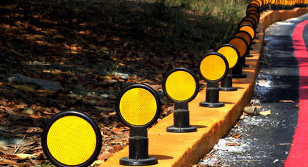 Road reflector beside a curved road,Traffic reflector,Road reflector 