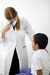 Female pediatrician professional specialist doctor with a small child as a patient taking her data and symptoms

