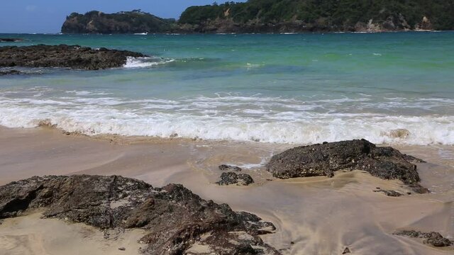 Volcanic rock and waves - Matapouri Beach - New Zealand
