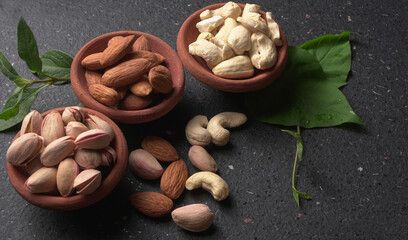 Pistachios or Pista nuts decorated with green leaves. plain background, top view.Flat lay.