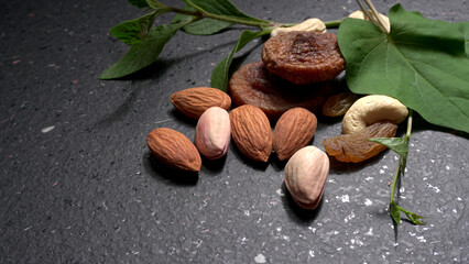 Pistachios or Pista nuts decorated with green leaves. plain background, top view.Flat lay.