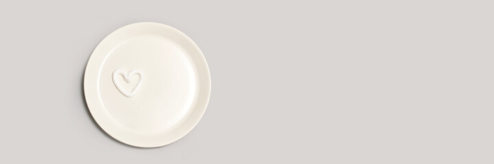 Heart shape cream. Beauty lotion. Mayonnaise smear on white plate. Top view with copyspace. White product smear. Valentine concept