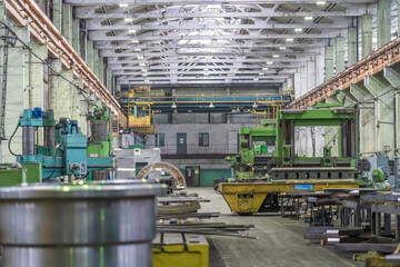 Fototapeta premium Metalwork factory with machines and lathes for processing metal production, industrial interior.