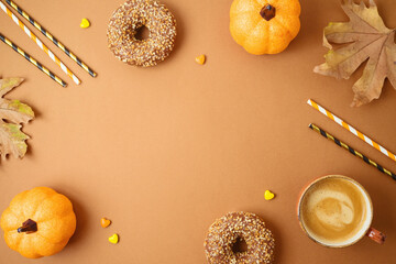 Coffee cup, donuts, pumpkin decor and autumn leaves. Fall season concept background.