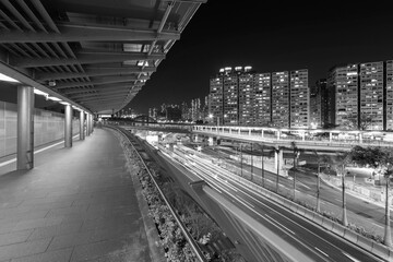 Empty modern pedestrian walkway and traffic in Hong Kong city at night
