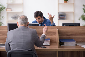 Two male employees working in the office