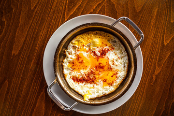 Delicious fried eggs on wooden background with space for text. 