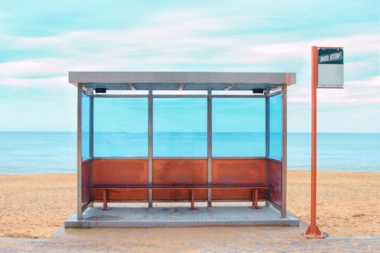A bus stop is located in the background of the beach.
