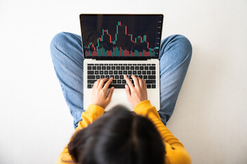 Investment financial stock market concept. Top view woman using computer laptop with application trading stock on screen device