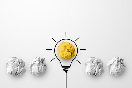 Concept creative idea and innovation. Paper scrap ball yellow colour outstanding different group with light bulb symbol