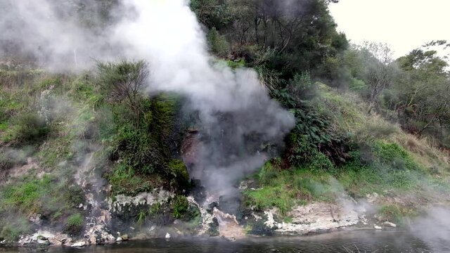 Waimangu Volcanic Rift Valley Cathedral Rock on Frying Pan Crater Lake releasing steam in Rotorua, New Zealand Aotearoa