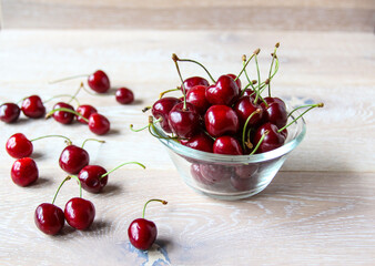 Naklejka na ściany i meble Fresh ripe red berries on a bowl on the rustic background