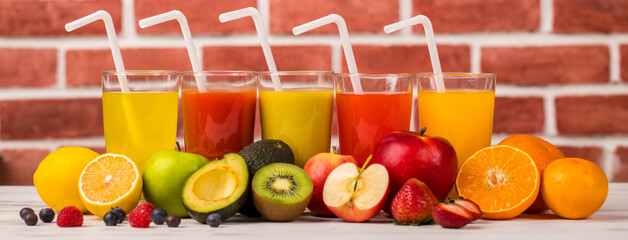 Different fruits juice in glass, apple, orange and strawberry juice with straw, looking refreshing...