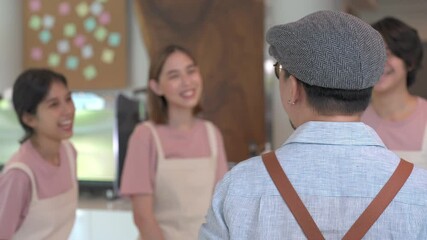4K Asian male coffee shop manager briefing man and woman staff team before working. Small business cafe and restaurant owner instruct part time employee preparing service to customers before opening